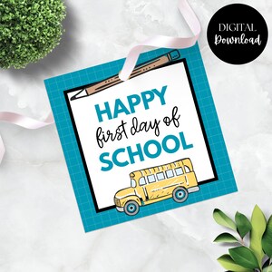 May include: A square teal tag with a black border and the words "HAPPY first day of SCHOOL" in teal and black. A yellow school bus illustration is at the bottom. A pencil illustration is at the top. A black circle with "DIGITAL Download" is in the upper right.