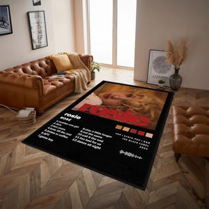 May include: Black rectangular area rug featuring the album art for "Rosie" by Rose. The design includes a portrait of the artist, song titles, and the text "POP I SYNTH-POP I R&B THE BLACK LABEL 2024".