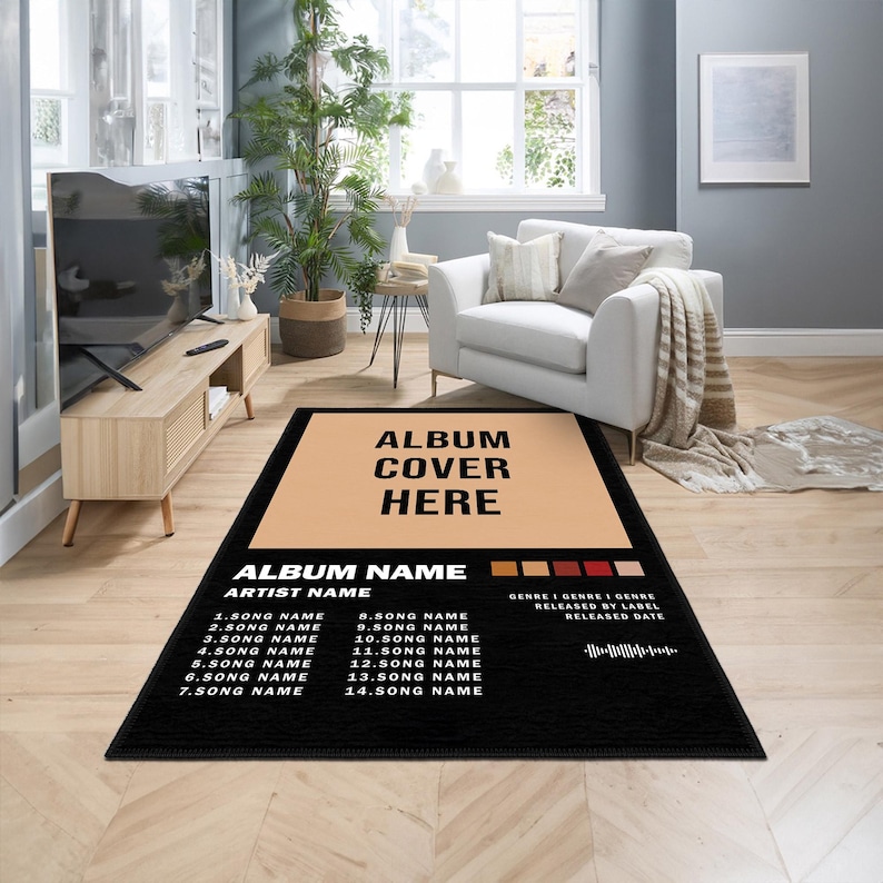 May include: Black rectangular rug with a tan center, featuring the text "ALBUM COVER HERE" and a tracklist. The rug includes the text "ALBUM NAME" and "ARTIST NAME". The rug is placed on a wooden floor in a living room setting.