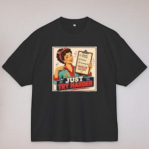 Peut inclure: Un t-shirt noir à manches courtes avec un graphisme rétro représentant une personne pointant un presse-papier avec les cases Difficulty Focusing, Burnout et No Energy Left cochées, et le texte PROBLEM SOLVED et JUST TRY HARDER en dessous.