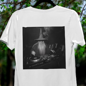 May include: A black and white photograph of a wizard wearing a pointed hat and a long beard, mixing music on a DJ mixer.