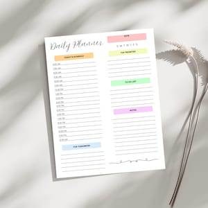 May include: A printable daily planner with a colorful design. The planner includes sections for today's schedule, top priorities, to-do list, and notes. The planner is designed to help you stay organized and on track.
