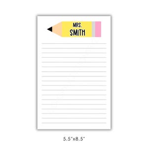 May include: A lined notepad with a pencil-themed design. The top features a yellow pencil with a black tip and pink eraser, and the name "MRS. SMITH" in black. The notepad measures 5.5" x 8.5".