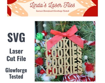 May include: Gold glitter Christmas ornament with a red bow and the word "COOKIES" repeated four times. The ornament is hanging on a Christmas tree with red and white candy canes.