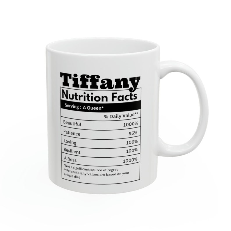 May include: White ceramic mug with the name "Tiffany" and "Nutrition Facts" printed in black. The mug features a nutrition label with values for "Beautiful," "Patience," "Loving," "Resilient," and "A Boss."