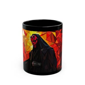 May include: Black ceramic mug with a colorful geometric design featuring Darth Maul from Star Wars. The design is a mosaic of red, orange, and yellow.