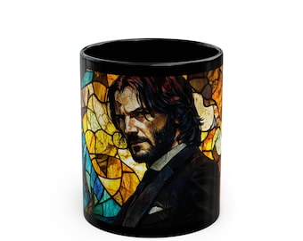 May include: Black ceramic mug with a stained glass design featuring a man with dark hair and a beard. The stained glass design is in shades of yellow, orange, blue, and green.