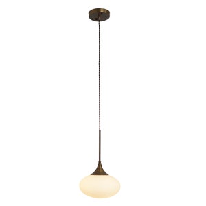 May include: A brass pendant light with a white frosted glass shade in the shape of a teardrop.