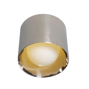 May include: A silver and gold ceiling light fixture with a round, white light bulb.