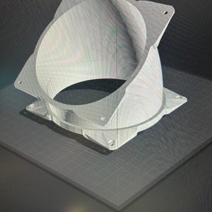 May include: A 3D-printed white object with a circular opening and square base. The object has a cylindrical shape with a flared top and four holes in the corners of the base. The object is sitting on a gray surface.