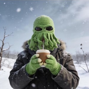 May include: A bright green crocheted balaclava featuring a tentacled face mask design with dark oval eye openings, paired with matching green crocheted gloves that have light-colored fingertips, worn with a dark winter jacket with a fur-lined hood.