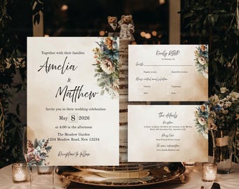 Op de afbeelding: Huwelijksuitnodigingsset met een rustieke, vintage uitstraling. De uitnodiging heeft een bloemenontwerp met een aquareleffect en de tekst "Amelia & Matthew" in een handschrift. De RSVP-kaart bevat een bloemenontwerp en de tekst "Graag RSVP vóór 15 februari". De kaart met details heeft een bloemenontwerp en de tekst "De details Receptie na afloop".