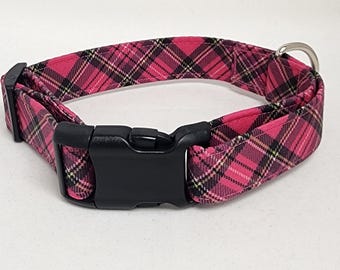 May include: Pink and black plaid dog collar with a black plastic buckle.