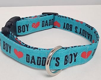 May include: A turquoise blue dog collar with the text "Daddy's Boy" and red hearts.