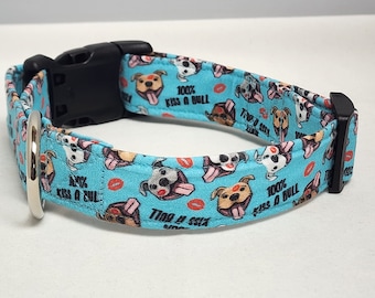 May include: A blue dog collar with a repeating pattern of cartoon bulldogs with the text "100% Kiss a Bull" and red lips.