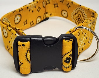 May include: A yellow dog collar with a black paisley pattern and a black plastic buckle.