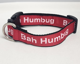 May include: Red dog collar with black trim and white text that reads "Bah Humbug" on one side and "Humbug" on the other side.