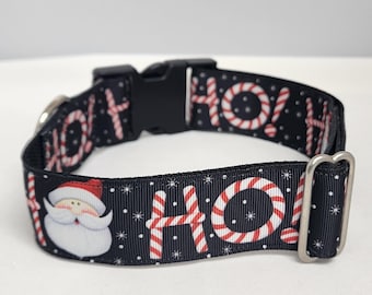 May include: Black dog collar with a white and red candy cane pattern and the word "HO!" repeated. A Santa Claus face is also featured on the collar.