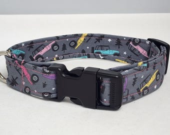 May include: A gray dog collar with a black buckle. The collar has a pattern of colorful cartoon off-road vehicles and stars.