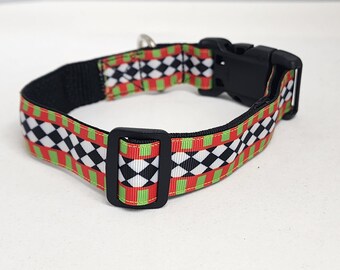 May include: A black and white checkered dog collar with red and green stripes. The collar has a black plastic buckle.