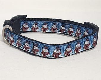 May include: A blue and black dog collar with a snowman pattern.