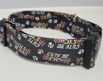 May include: Black dog collar with white paw prints and the text "Cute but Psycho" repeated in a colorful font.