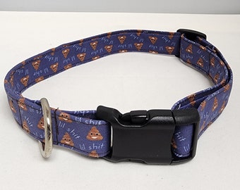 May include: A purple dog collar with a repeating pattern of brown poop emojis and the text "lil shit".