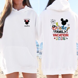 May include: White hoodie with a colorful Disney Family Vacation 2025 graphic on the back and a small Minnie Mouse graphic on the front with the text "Disney 2025 Monica".