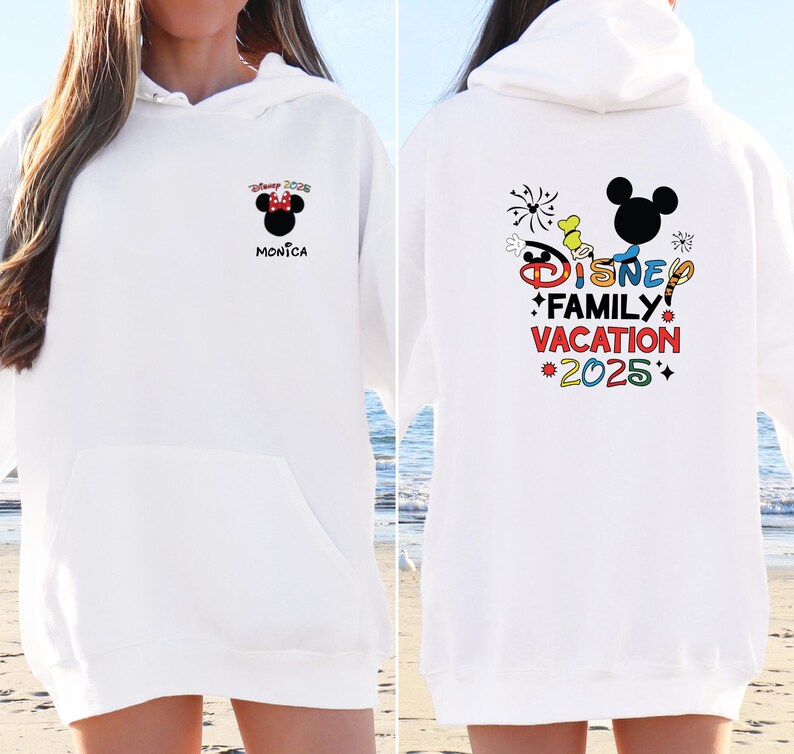 May include: White hoodie with a colorful Disney Family Vacation 2025 graphic on the back and a small Minnie Mouse graphic on the front with the text "Disney 2025 Monica".