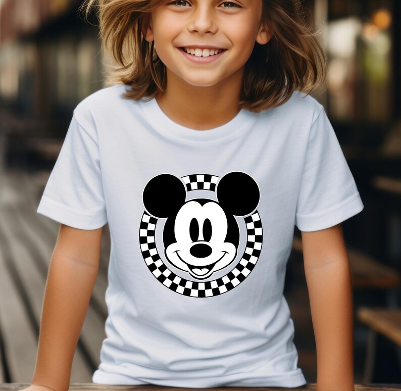 May include: White t-shirt with a black and white checkered circle around a black and white cartoon Mickey Mouse face.