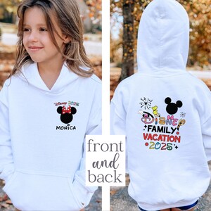 May include: White hooded sweatshirt with a Mickey Mouse design on the front and a colorful Disney Family Vacation 2025 design on the back. The front design includes the text "Disney 2025" and "Monica".