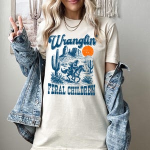 Retro Wranglin&#39; Feral Children Raccoon Shirt, Vintage Western Raccoon Comfort Shirt, Funny Mom Shirt, Raccoon Shirt, 90s Western Desert Tee