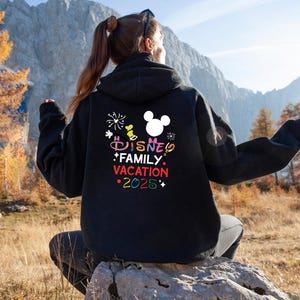May include: Black hoodie with a colorful graphic that says "Disney Family Vacation 2025" and a white Mickey Mouse head silhouette.