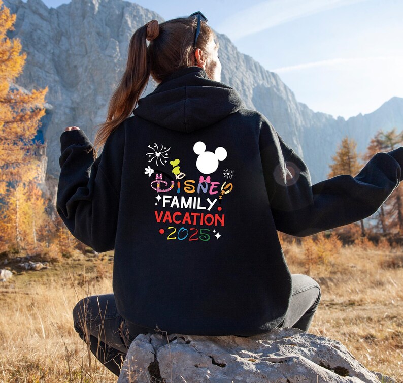 May include: Black hoodie with a colorful graphic that says "Disney Family Vacation 2025" and a white Mickey Mouse head silhouette.