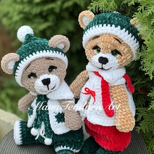 May include: Two crocheted teddy bears wearing green and white winter outfits. The bear on the left is wearing a green hat with a white pom-pom and a green and white sweater. The bear on the right is wearing a green hat with a white trim and a red and white sweater.
