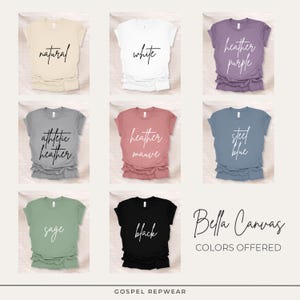 May include: A grid of nine t-shirts in various colors, including natural, white, heather purple, athletic heather, heather mauve, steel blue, sage, and black. Each shirt displays its color name in cursive script. The text "Bella Canvas COLORS OFFERED" is also present.
