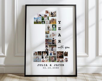 May include: A black framed photo collage of a couple's photos arranged in the shape of the number one. The text "1 YEAR with you" is printed below the collage. The names "JULIA & JACOB" and the date "02.14.20XX" are printed below the text.
