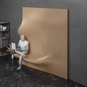 May include: A person sits on a wooden, wave-shaped bench in a modern room with black and white marble floors. The bench is part of a wall panel with a wood grain pattern. The room also features a black metal shelf unit with books and a black metal shelf with a framed photo.