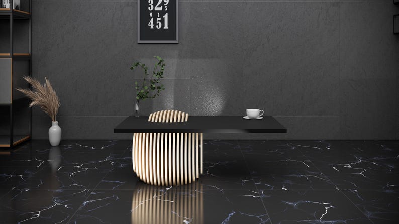 May include: A black table with a wooden slatted chair in front of it. The table has a white cup and saucer on it. The table and chair are in a room with black marble floors and a black wall.