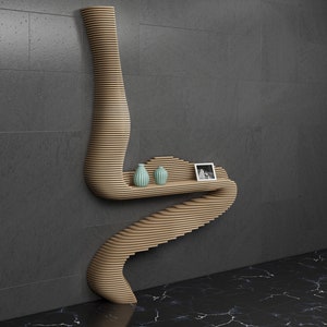 May include: A wooden wall shelf with a unique, curved design. The shelf has three levels and is decorated with two small, light blue vases and a framed photo.
