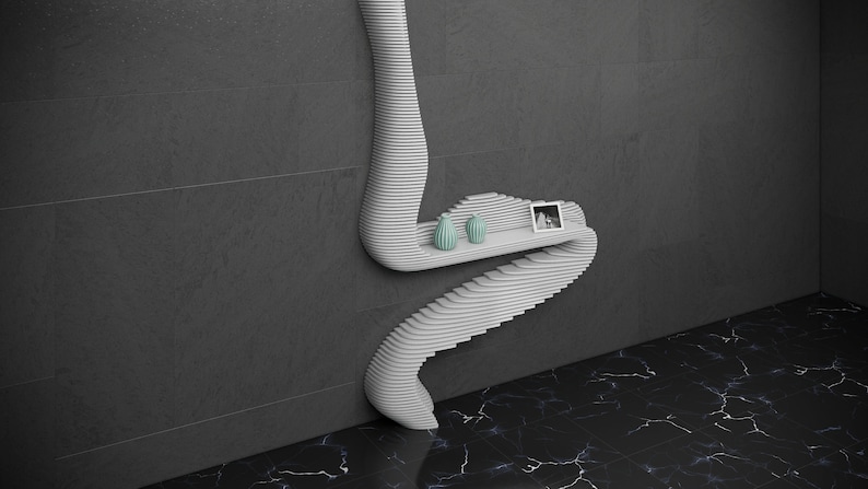 May include: White wall-mounted shelf with a unique, wavy design. The shelf has two small teal vases and a framed photo on it.