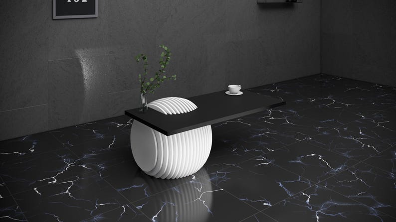 May include: A black and white coffee table with a round, white base and a black rectangular top. The table is on a black and white marble floor.