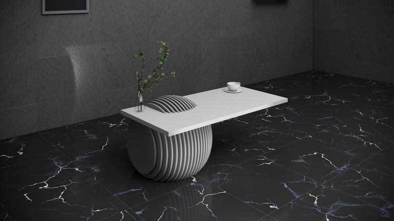 May include: A white coffee table with a round, layered base and a rectangular top. The table is on a black and white marble floor.