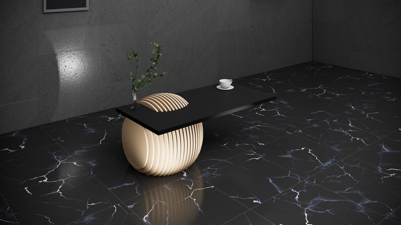 May include: A black and gold modern coffee table with a round base and a rectangular top. The table is made of wood and has a unique design.