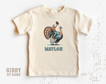 Cowboy Riding Turkey Kids Shirt: Custom Text Thanksgiving Graphic Tee ( GF6814 )