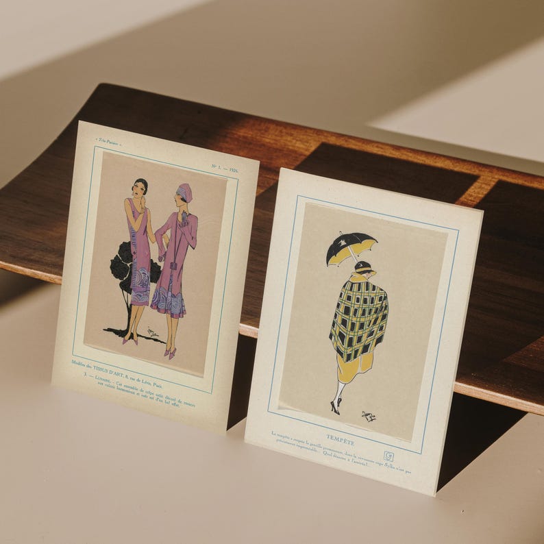 May include: Two vintage fashion illustrations. One features two women in purple dresses, the other shows a woman in a yellow dress and a black and yellow checkered coat holding a black umbrella. The illustrations are on aged paper.