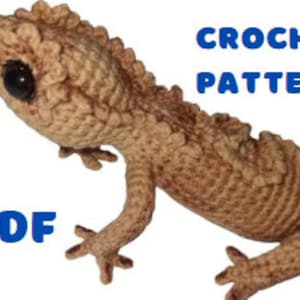 May include: Crochet pattern PDF for a brown crocheted gecko with black eyes. The pattern is available for download.