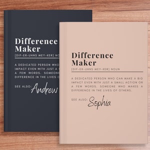May include: Two hardcover notebooks with the text "Difference Maker" and a definition. One notebook is dark blue, the other is light beige. The definition describes someone who makes a big impact. The names "Andrew" and "Sophia" are also included.