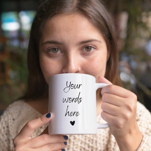 May include: White ceramic mug with a black handwritten message that says "Your words here" and a small black heart.
