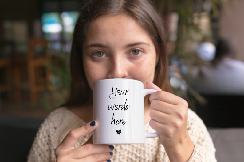 May include: White ceramic mug with a black handwritten message that says "Your words here" and a small black heart.